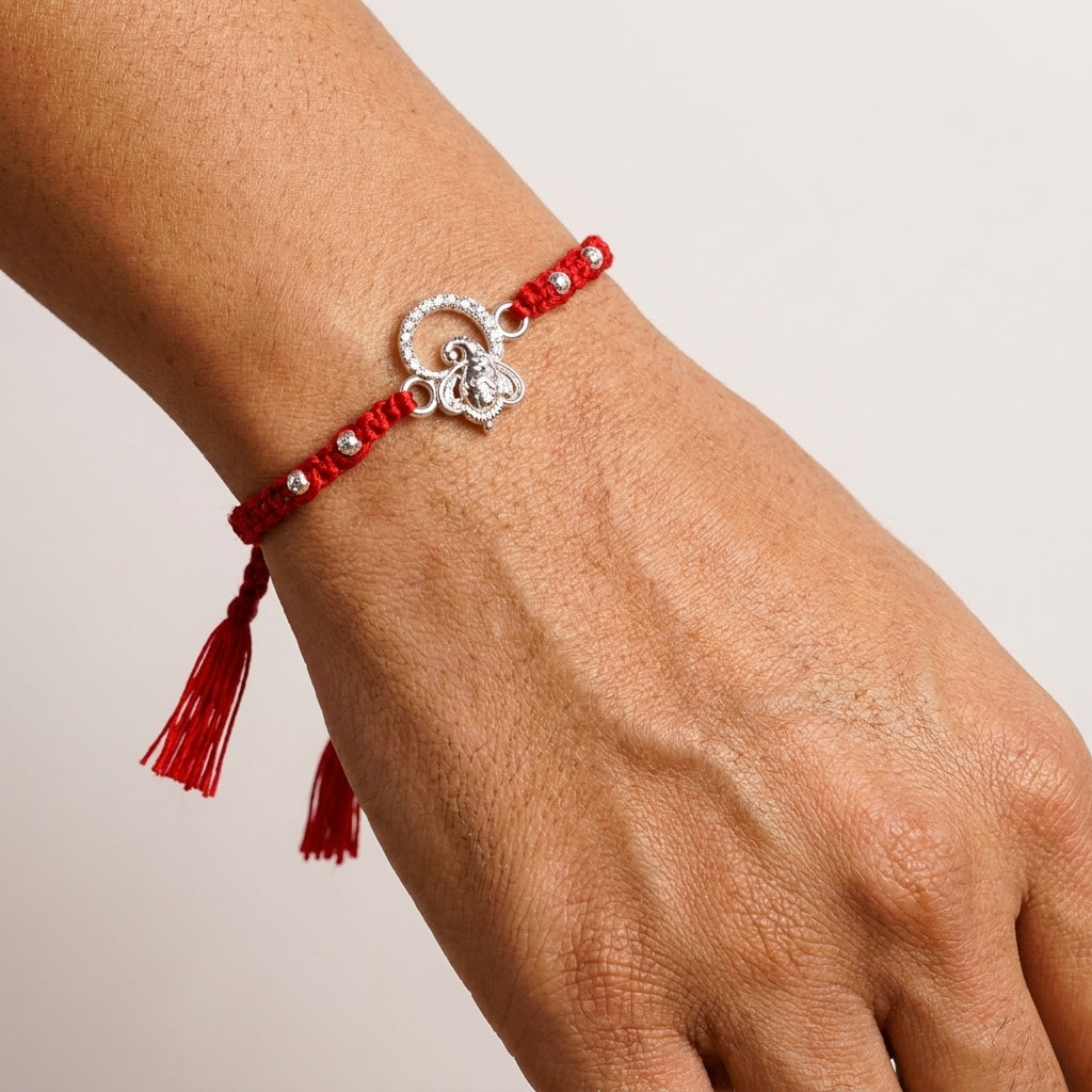 Silver Ganesha Rakhi with Red Tassel